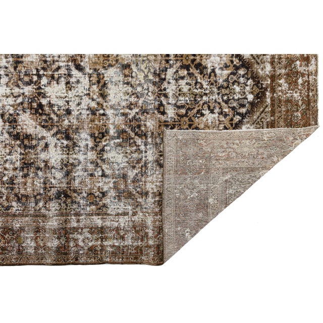 This striking late 19th to early 20th-century Antique Mahal wool rug is a masterclass in lived-in luxury. Characterized by...