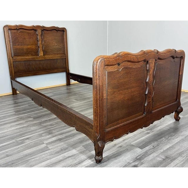 This Vintage French Louis single bed frame displays classic continental elegance with finely shaped panels and a warm oak...