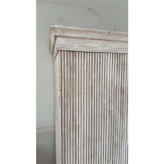 A stately and sophisticated pair of large Gustavian-style cabinets, masterfully crafted from reclaimed Italian pine and...