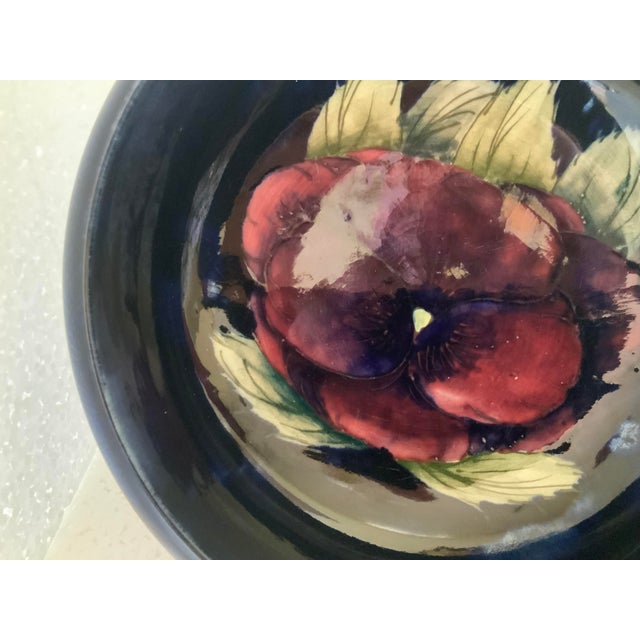 Hand painted purple and pink shaded Pansy accented with green leaves around exterior rim of bowl