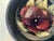 Hand painted purple and pink shaded Pansy accented with green leaves around exterior rim of bowl