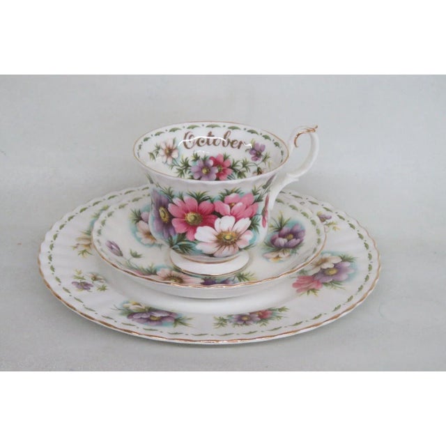 This lovely tea cup, saucer, and dessert plate set is made of bone china. This set is stamped as being made by Royal...