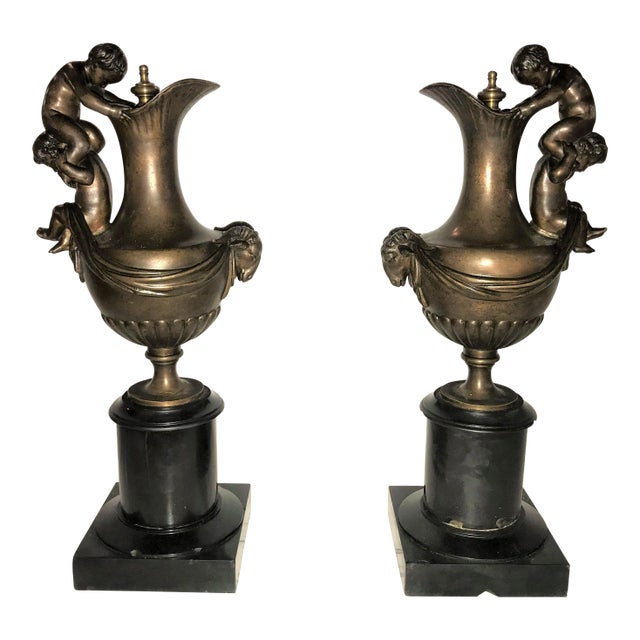 19th C. Urns on Marble Stands Bearing Cherubs & Rams Heads - a Pair For Sale