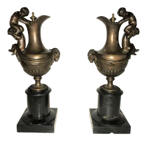 19th C. Urns on Marble Stands Bearing Cherubs & Rams Heads - a Pair