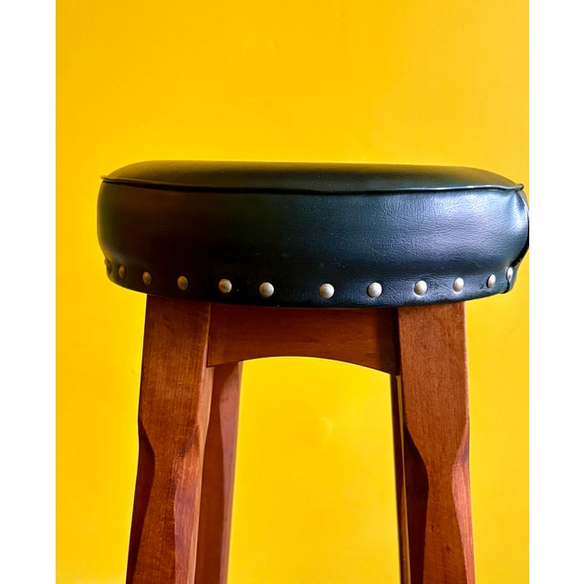 A set of sturdy bar stools made in Europe in the 1960s. Crafted from solid wood, these stools feature a sturdy...