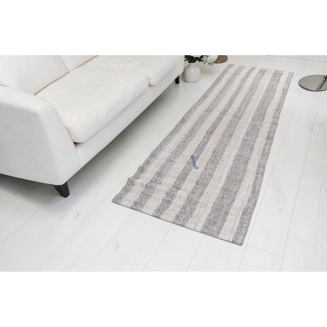 This is a vintage Turkish Oushak rug from the Mid 20th Century. The piece was hand-knotted.