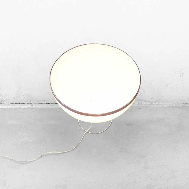 Vintage tripod table lamp with an industrial look and feel. The lampshade is open at the top and made from white plastic...