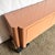 This striking postmodern credenza showcases bold sculptural form wrapped in a glossy salmon pink laminate, embodying the...