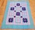 43” x 55” Beautifully hand-crafted American Amish pieced cotton quilt in a “Churn Dash” pattern from Lancaster County,...