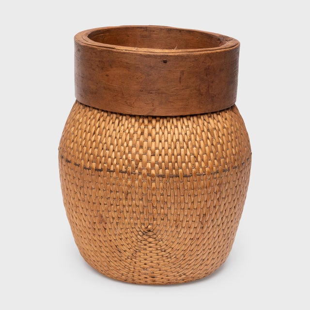 A testament to the weaver's skill, this antique Chinese fisherman’s basket from the early 20th century remains in...