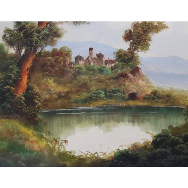 A romantic landscape with a small lake or pond in the foreground reflecting the surrounding vegetation, lush trees, and...