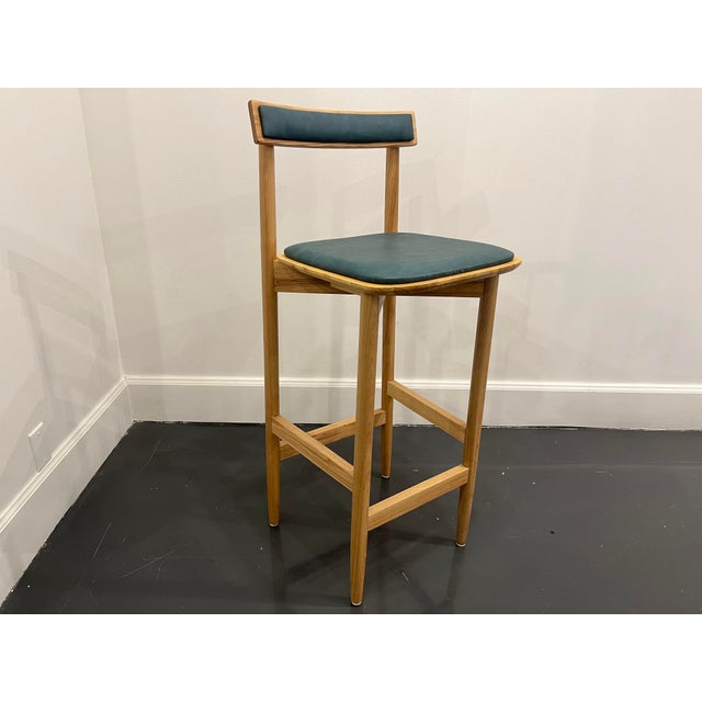 Made by Mark Oliver Custom solid wood/Leather upholstered Barstools light teal leather in good condition overall used in...