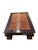 Large low-profile coffee table crafted from solid elm wood with a rich, dark finish. It features an inset slatted rattan...