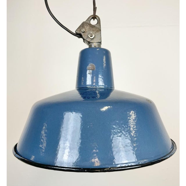 Industrial blue enamel pendant light made by Polam Wilkasy in Poland during the 1960s. White enamel inside the shade. Cast...