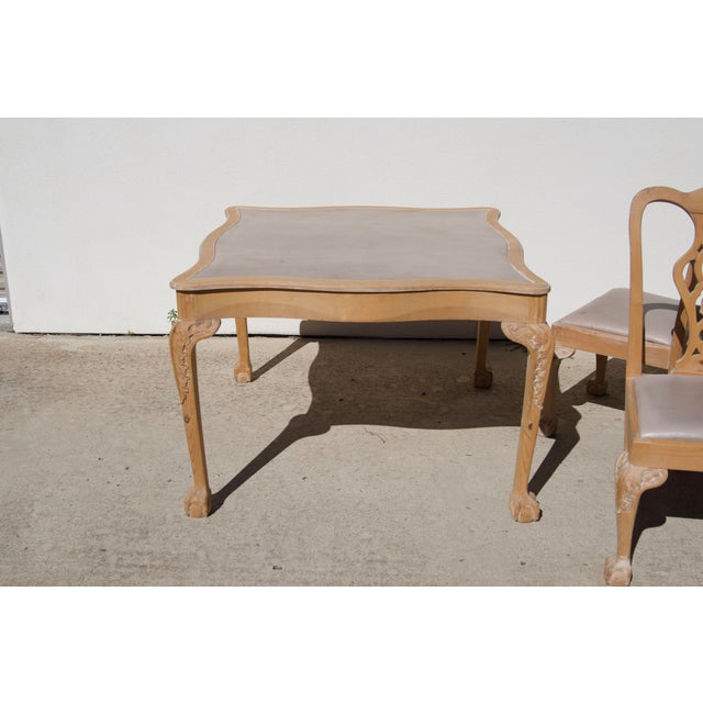 A five-piece Chippendale-style game set, a square game table and four matching side chairs, made by a Southern California...