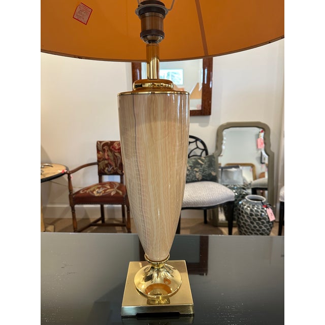 Pair of 1970s pink striated glass table lamps with polished brass bases. These were sourced from the famous Les Puces flea...