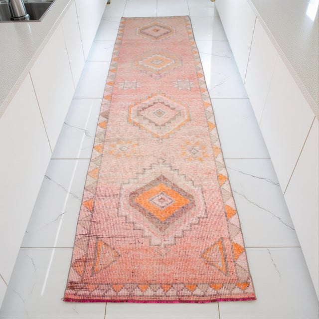 Woven on a traditional family loom in Eastern Anatolia during the 1960s, this authentic vintage runner rug was originally...