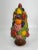 Fantastic topiary manufactured by Holland Mold that depicts a variety of vividly colored fruit stacked upon a base....