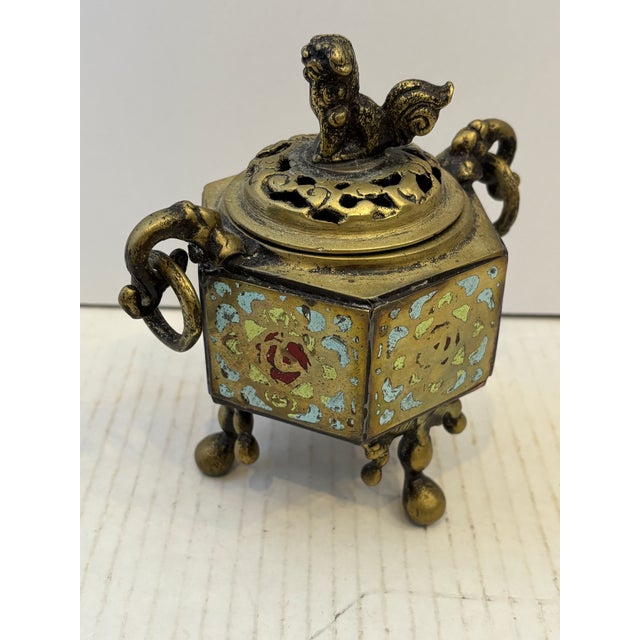 100 years old Chinese tripod incense burner or censer. It features gild-bronze body decorated with colorful enamel in a...