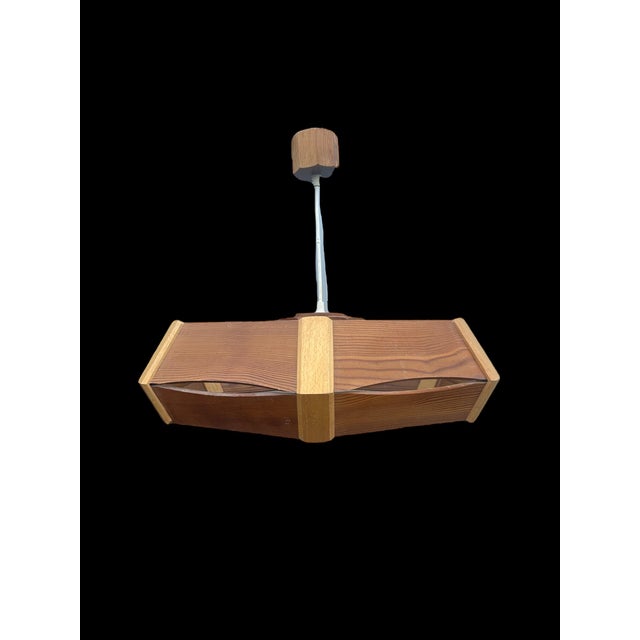 Brutalized wooden chandelier from the 70s, Pierre Even edition wooden base diameter 55cm height 15cm This piece has an...