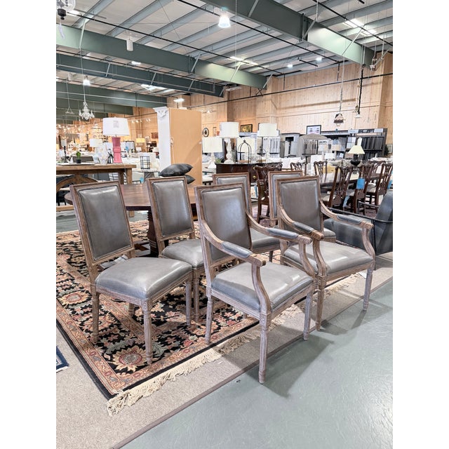A refined set of six French square back dining chairs by Restoration Hardware, including two armchairs and four side...