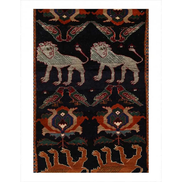 This Shiraz carpet originates from Persia and has been knotted from nomads in a smaller town. Its size is 3'3" by 9'3''...