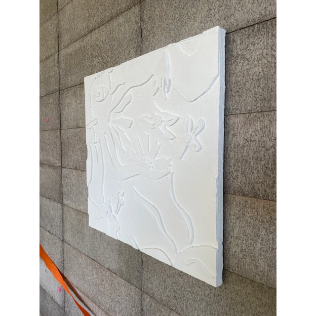Textured relief with abstract botanical and organic forms. The raised surface creates gentle shadows and dimension, giving...