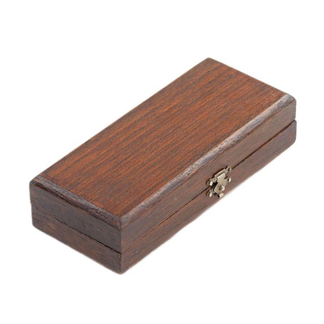 A rare collector`s item—a miniature violin model in its original case, crafted from varnished wood with decorative silver...