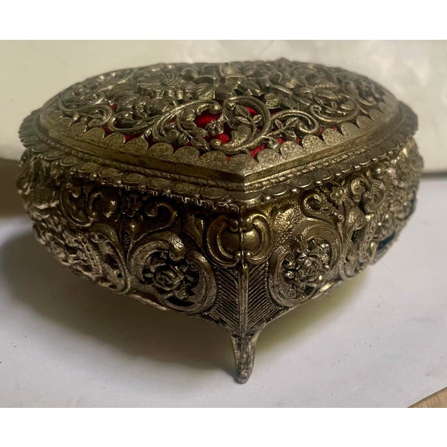 This is the sweetest little box with a hinged top that has molded metal shaped as flowers and vines intertwined on the top...