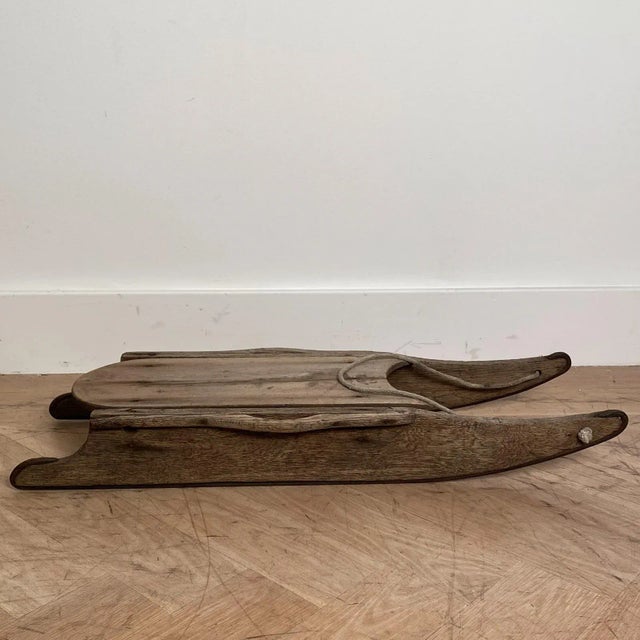 A small scale American wood sled in oak with iron runners