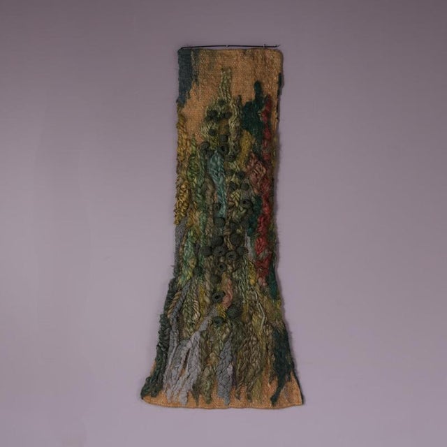 Dating from the 1970s, this striking wall-mounted tapestry was made in the Netherlands. The work is created from richly...