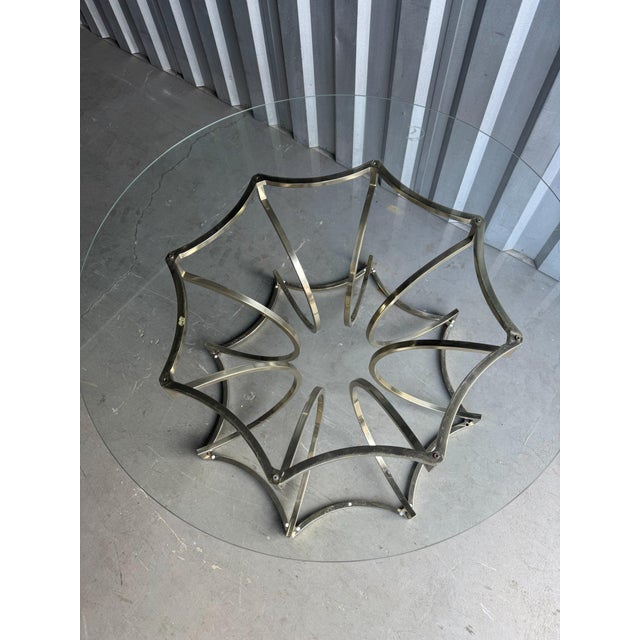 A Bernhardt centre table built from sweeping brass-finish bands that cross and arch into an eight-point star at both the...