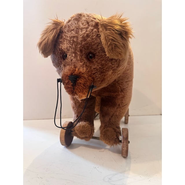 This charming vintage plush bear pull toy combines nostalgic craftsmanship with playful functionality. The bear is covered...