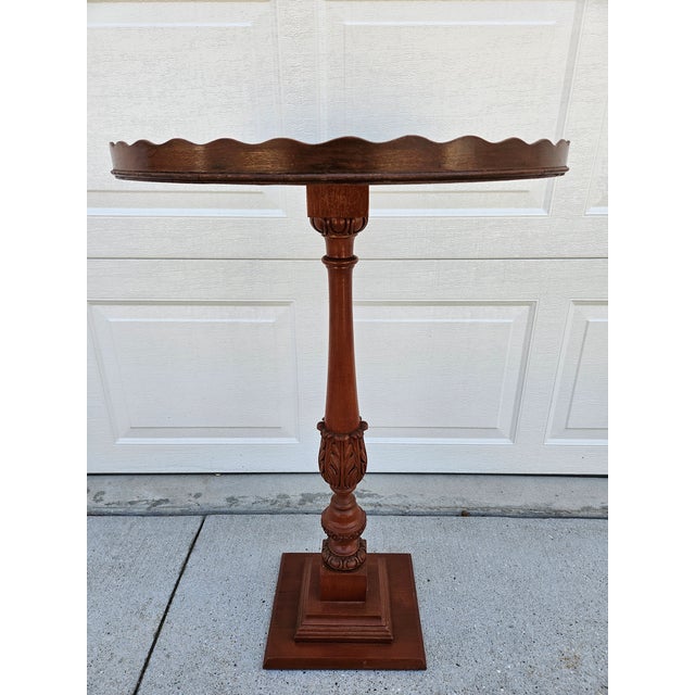 This tall mahogany piecrust pedestal side table is work of folk-art or the creation of an imaginative woodworker. It is a...