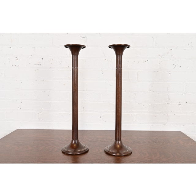 A beautiful pair of Arts & Crafts period sterling silver on bronze tall candlesticks By Silver Crest (the mark of Smith...