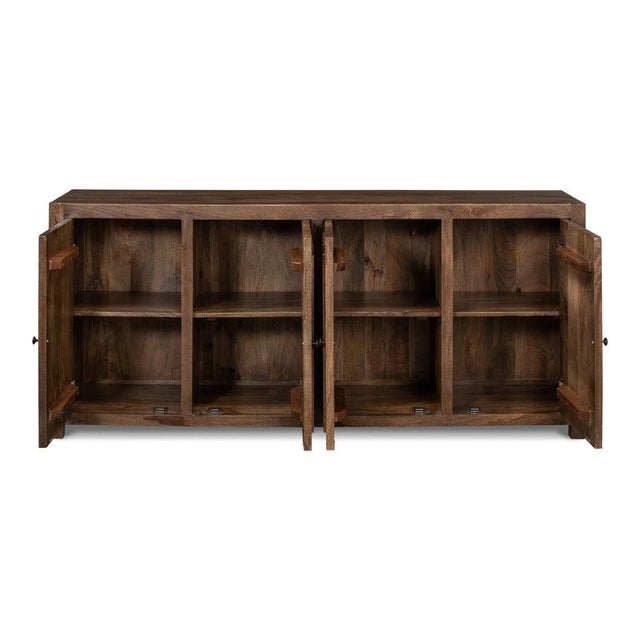 Applied moldings step inward at the corners of four paneled doors, creating bracketed rectangles across a plain hardwood...