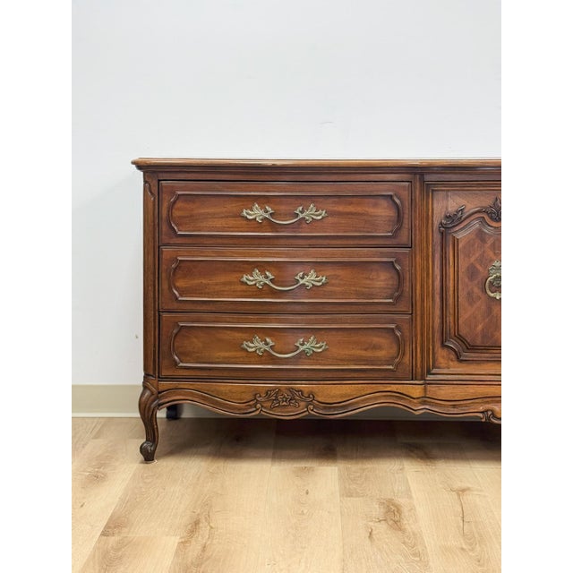 This impressive vintage Thomasville French Provincial 9-drawer dresser is a beautifully crafted and ornate bedroom anchor...