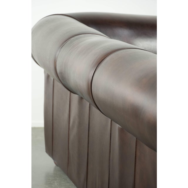 We are offering this luxurious brown cowhide leather set, consisting of a smooth Chesterfield sofa and armchair with a...