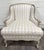 This is an elegant vintage Sam Moore bergère lounge chair featuring a carved Louis XV style hardwood frame with champagne...