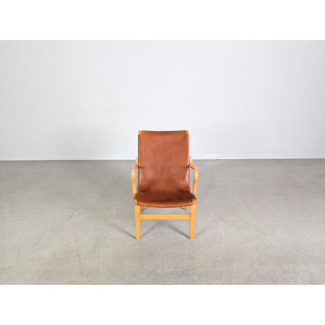 We are offering a beautiful Swedish "EVA" armchair by Dux of Sweden for sale. Made of beechwood and saddle leather, this...