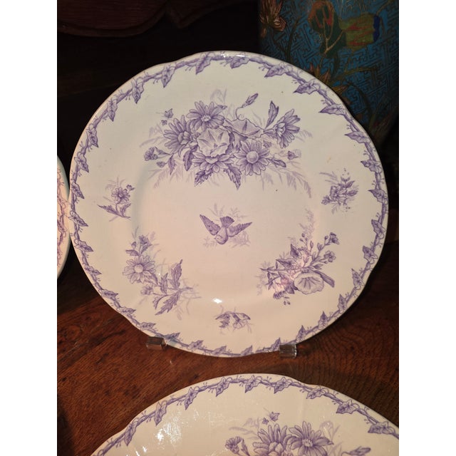Pretty collection of three plates and one smaller plate. Late 19th century and from France. Purple foliage withe a bird in...