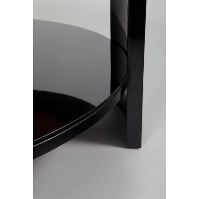 Coffee table in black polish with turnable upper board fitted by black glass, equipped by chrome accessories. Source:...