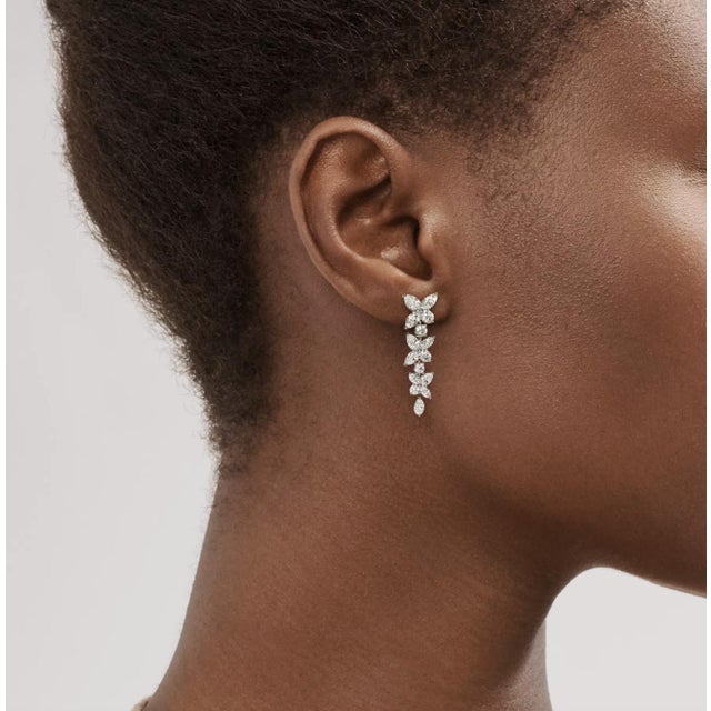 These stunning earrings by Tiffany & Co. in their Victoria Collection contain clusters of marquise, pear and round...