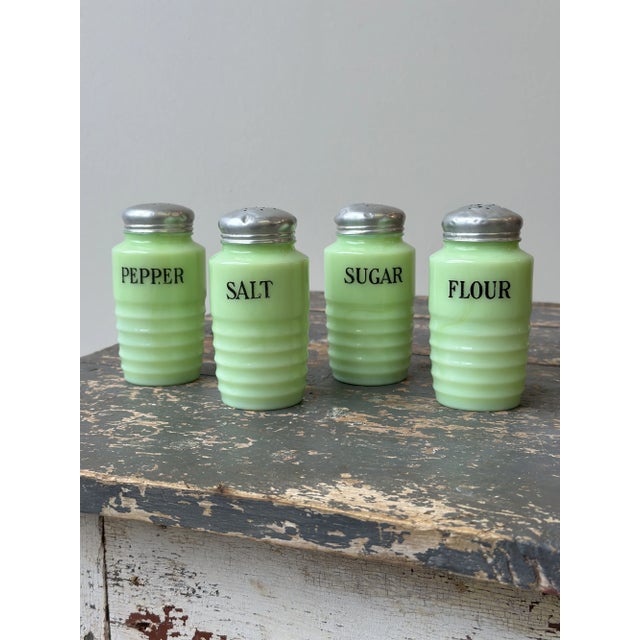 Vintage Jeanette Glass Jadeite Shakers, Set of Four, Circa 1950s. Molded, ribbed jadeite glass body with a screw on...