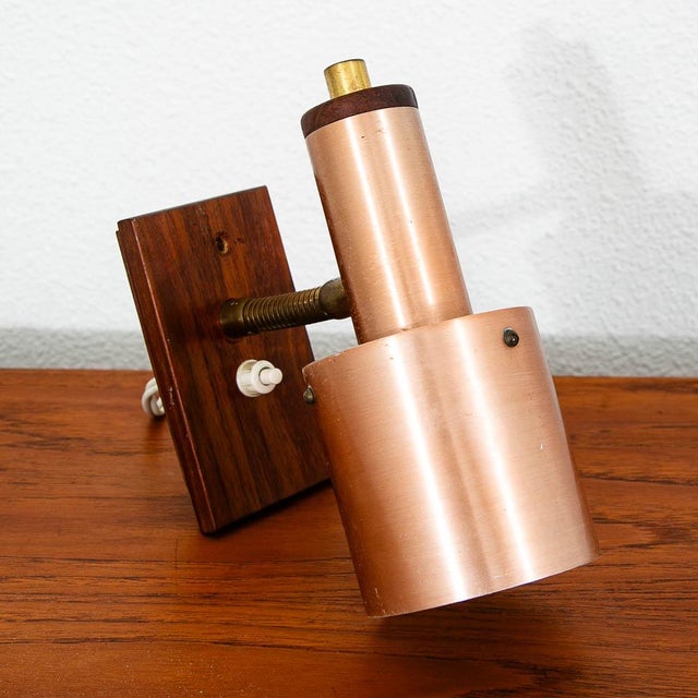 Unique copper and rosewood wall sconce. Recently imported from Denmark. Comes with a European plug so an adapter or...