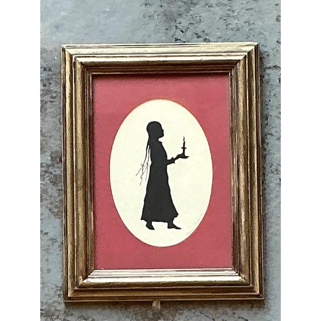 This vintage silhouette portrait presents a captivating study in contrast, with a crisp black profile figure set within a...