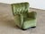 A Danish wingback lounge chair in moss green velvet, circa 1940s. The form is full and generously proportioned — deep...