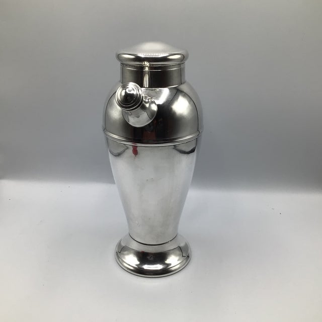 Large Art Deco style prohibition era silver plated cocktail shaker by the International Silver Company. Shaker has a heavy...