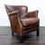 This Restoration Hardware lounge chair features rich brown leather upholstery with stylish nailhead trim. The seat is...
