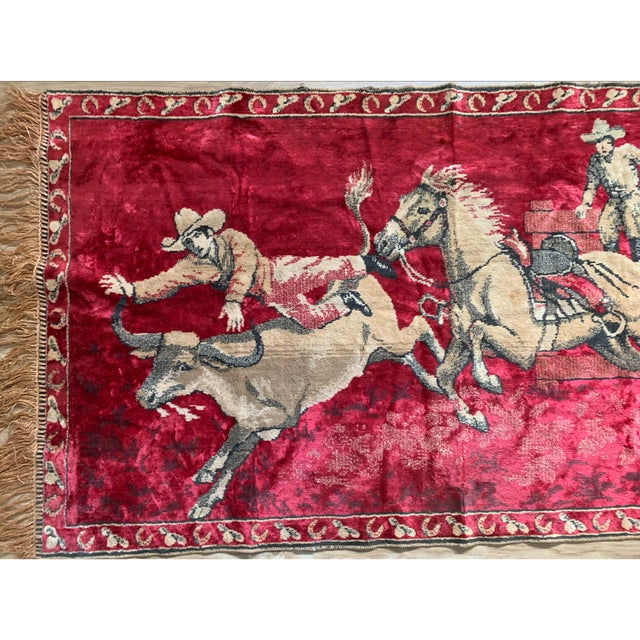 A striking vintage Western pictorial textile featuring a dynamic rodeo scene with cowboys, horses, and steer wrestling set...